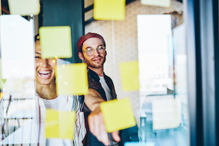 people smiling with sticky notes